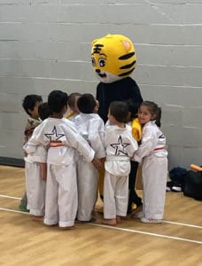 Students at Star Martial Arts in Milton Keynes with a Tiger mascot